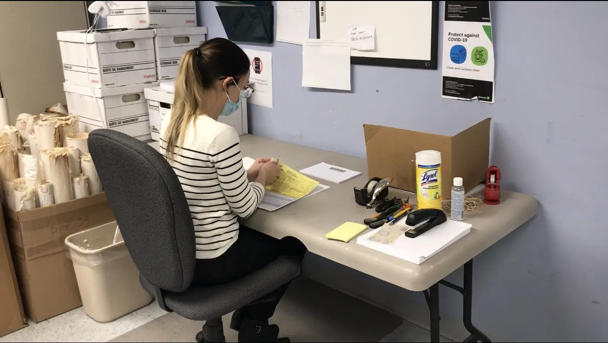 Polar Imaging specialist preparing paper records for secure document scanning