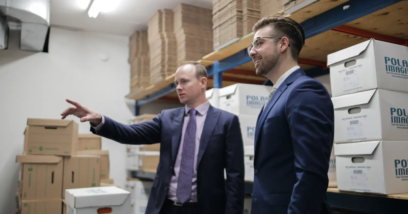 Polar Imaging team reviewing a document scanning project beside securely staged records